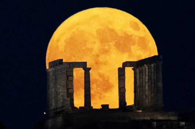 Bulan purnama "Biru" terlihat indah di belakang Kuil Poseidon di Tanjung Sounio, sebelah selatan Athena, Yunani.